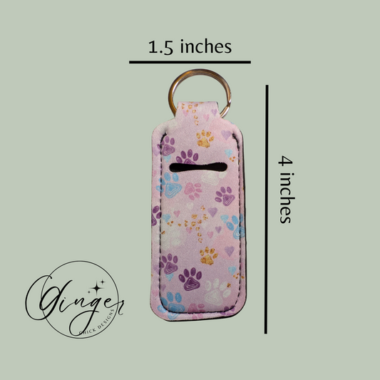 Keychain with paw print pattern and measurements on a light green background