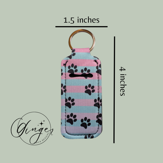 Keychain with paw print pattern and dimensions on a light green background