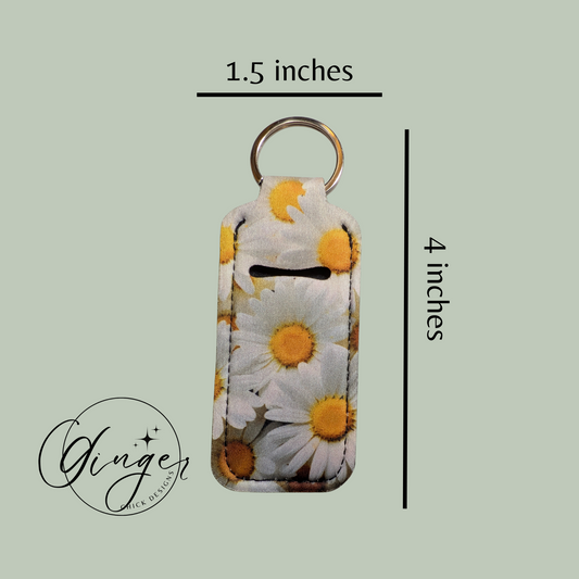 Keychain with daisy pattern and measurements on a light green background