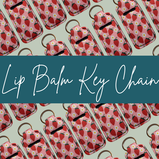 Lip balm key chains with strawberry pattern on a light green background