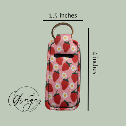 Keychain pouch with strawberry pattern and dimensions on a light green background