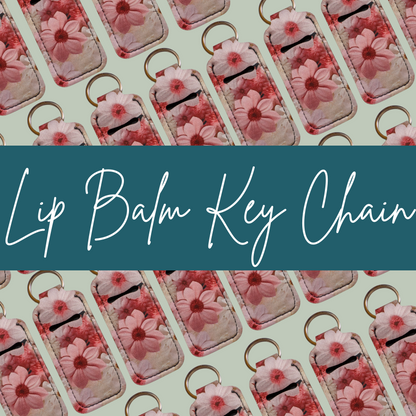 Pattern of lip balm key chains with floral design on a light green background.