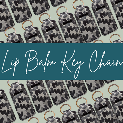 Lip balm key chains with camouflage pattern on a light green background