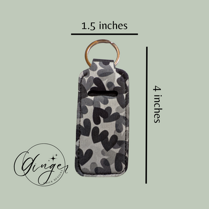 Camouflage-patterned keychain with dimensions on a light green background