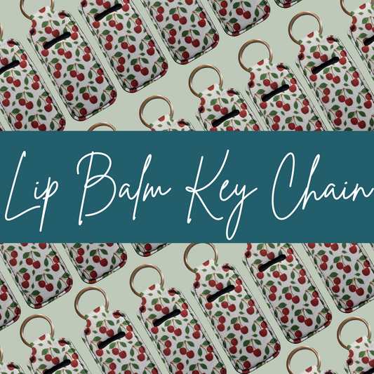 Lip balm key chains with cherry pattern on a light green background