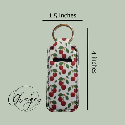 Keychain with cherry pattern and measurements on a light green background