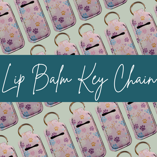 Lip balm key chains with paw print design on a light green background