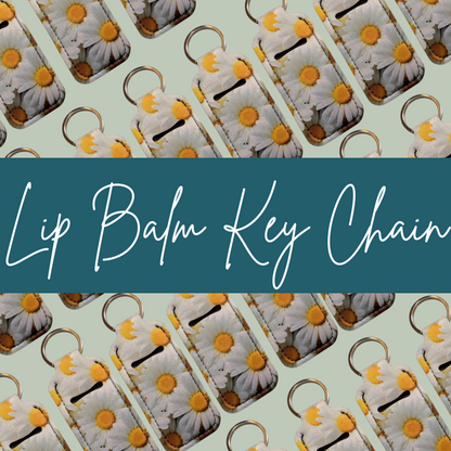 Lip balm key chains with daisy design on a light green background