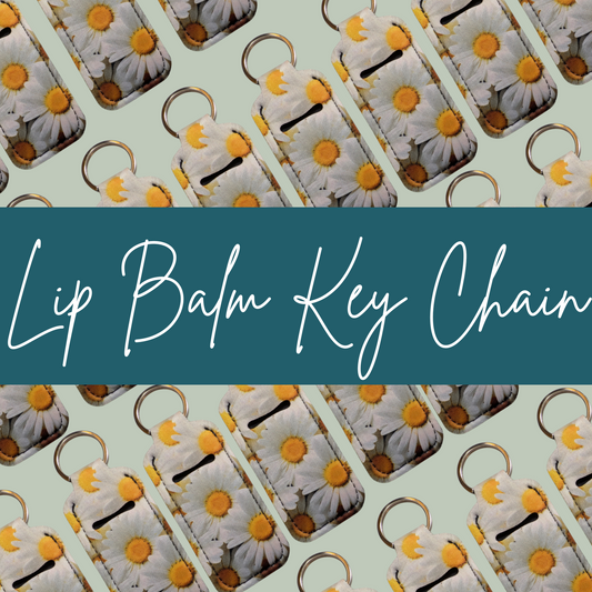 Lip balm key chains with daisy design on a light green background